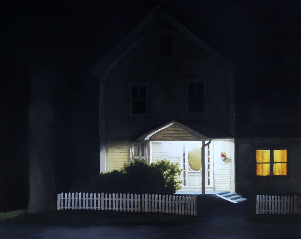 A house in the dark with the porch light lit
